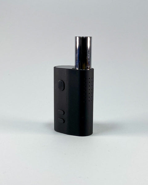 Mini dry herb vaporiser device in black with ergonomic grip and tactile body.