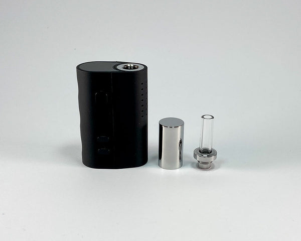 Mini dry herb vaporiser. Disassembled with mouthpiece and cap.